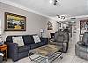 The open living area of this beautiful unit features plenty of comfortable seating and a sofa sleeper for additional, overnight guests.