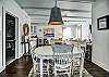 The dining area offers a table with seating for 4, and is the center point of this cute cottage.