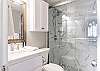 This private bathroom features a standing shower, single vanity and is fully stocked with linens for your stay.