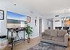 The living area features plenty of comfortable seating and a large television for unwinding and relaxing after a long day on the beach.