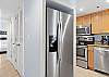 The spacious kitchen features a side by side fridge with ice and water in the door for convenience.
