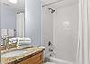The guest bathroom features a tub/shower combo, single vanity, and is fully stocked with linens for your stay.