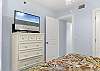 The guest bedroom features ample storage for your personal belongings, a television to help you unwind and relax at night, and private access to the guest bathroom for convenience.