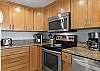 This fabulous kitchen features both small and large appliances which include a single cup coffee maker as well as a regular brewing pot.