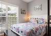 Guest bedroom offers comfortable queen bedding with bedside tables and lamps.