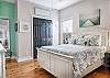 The primary bedroom features comfortable queen bedding and is beautifully furnished to make you feel right at home.