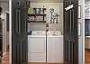 The spacious laundry closet features a full size washer and dryer for convenience.