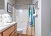 The spacious guest bathroom features a tub/shower combo, single vanity, and is fully stocked with linens for your stay.