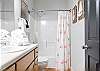 A private bathroom is featured in the primary bedroom for extra convenience and is fully stocked with linens for your stay.