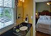 Single sink vanity with extra makeup counter off  the 1st of 2 bedrooms. 
This bathroom has a tub/shower combo.