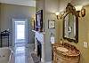 The luxurious master bathroom has 2 separate vanities, a jetted tub & walk-in closet.