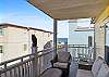 Balcony has cushioned, wicker seating and a great view of the Ocean from 17th Place!