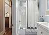 The full bathroom has a tub/shower combo.