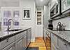 The spacious kitchen is newly remodeled and fully outfitted for a quick meal or cocktails!
A small washer/dryer is in the kitchen closet.