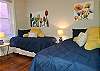 Our first bedroom has 2 brand new twin beds with colorful art and cushy pillows for the kids!