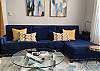 The daylight-filled living room is cozy & colorful!