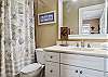 Full bath with tub/shower combo off the 3rd bedroom with twin beds.