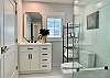 Completely renovated bathroom with a tub/shower combo. There is a full sized washer/dryer in the closet on left.