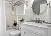 The hallway bathroom has a combo tub/shower, brand new flooring and vanity. The washer/dryer is located here as well.
