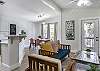 The home is spacious, open and sunlit! Kitchen, dining room an living room are all open to each other. The screened porch is just outside the door in photo.