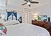 Split system AC unit in bedroom for tropical nights as well as a ceiling fan.