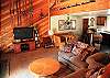 Spacious living room with plenty of seating and large flat screen TV.