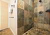 Bathrooms have slate step-in showers