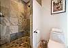 Bathrooms have slate step-in showers