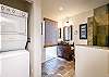 Guest bathroom has a stacked washer/dryer