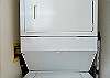 Stacked washer/dryer in unit