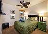 Ample lighting and a ceiling fan in the guest bedroom