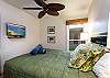 Queen bed with flat screen TV in guest bedroom