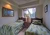 Twin beds in second guest bedroom
