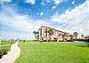 Exterior angle view of the building and sidewalk to the pool & walkover to the beach