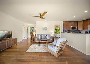 View of the living room, kitchen and bedroom on the right