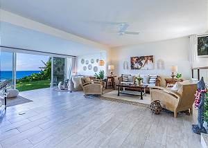 Large living space and the patio doors open to manicured grass 