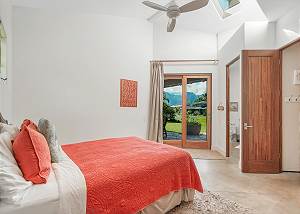 Guests room with high ceilings and vaulted skylight 