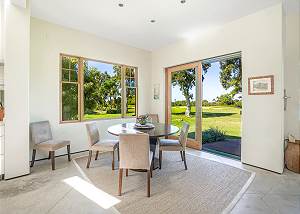 Dining area open to lush landscaping