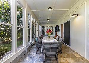 Enclosed sun room with dining table, TV, Yoga Mats