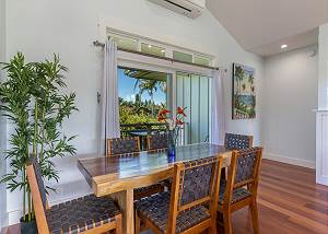 Dining area with lush backyard views
