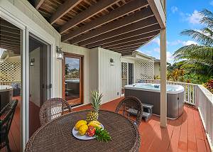 Back porch offers dining table and hot tub