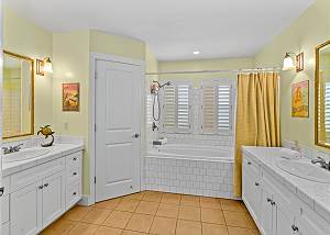 Master bath with tub and walk in closet