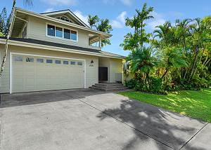 Two car garage and tropical foliage
