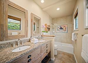 Master bathroom with dual sinks and bath tub