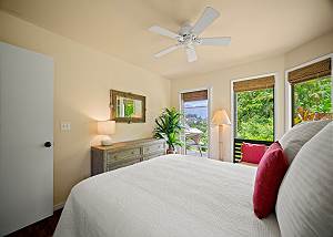 2nd bedroom with ceiling fan and lots of windows