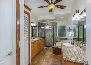 En suite bath with dual sinks and tub 