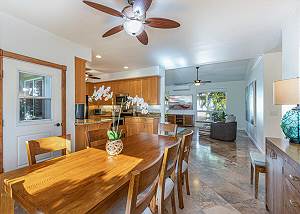 Dining room has ample lighting and flows into kitchen