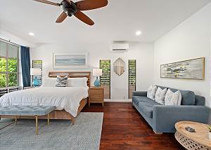 Primary bedroom with King bed and couch 