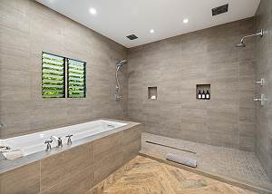 Primary full bathroom with tub and shower