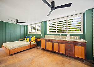 With a day bed and sink area for drinks and food